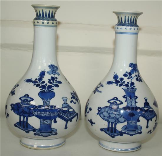 A pair of Chinese blue and white bottle vases, Kangxi period, 19.5cm, rims restored